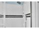 A white tiled shower stall with black accent stripe and multiple shower heads for a spa experience at 215 Collins Rd, Lillington, NC 27546