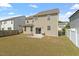 Grassy backyard with a small concrete patio, perfect for outdoor dining at 220 Outwater Ridge Dr, Garner, NC 27529