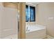 Bright bathroom featuring large soaking tub with dark curtains and separate shower at 220 Outwater Ridge Dr, Garner, NC 27529