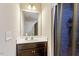 Bright bathroom featuring a single vanity and shower with dark wood cabinets at 220 Outwater Ridge Dr, Garner, NC 27529