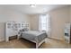 Bright bedroom with a full-sized bed, white headboard, and tan carpeting at 220 Outwater Ridge Dr, Garner, NC 27529