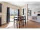 Sunlit dining area adjacent to the kitchen, featuring a chandelier and patio access at 220 Outwater Ridge Dr, Garner, NC 27529