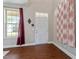 Foyer with hardwood floors, a large window, and a decorative accent wall at 220 Outwater Ridge Dr, Garner, NC 27529