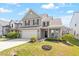 Charming home with manicured lawn, featuring a two-car garage and inviting front porch at 220 Outwater Ridge Dr, Garner, NC 27529