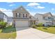 Well-kept home with two-car garage, complimented by a green lawn and blue skies at 220 Outwater Ridge Dr, Garner, NC 27529