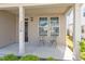 Inviting front porch with pillars, a dark-colored front door, and seating area at 220 Outwater Ridge Dr, Garner, NC 27529