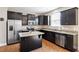 Modern kitchen with stainless steel appliances, dark cabinets, granite countertops and center island at 220 Outwater Ridge Dr, Garner, NC 27529