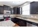 Well-lit kitchen featuring dark cabinets, stainless steel appliances, and granite countertops at 220 Outwater Ridge Dr, Garner, NC 27529