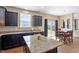 Eat-in kitchen features granite countertops, an island, and sliding glass doors to the patio at 220 Outwater Ridge Dr, Garner, NC 27529