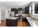 Modern kitchen with stainless steel appliances, dark cabinets, granite countertops and center island at 220 Outwater Ridge Dr, Garner, NC 27529