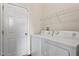 Functional laundry room with a washer, dryer, and storage shelving at 220 Outwater Ridge Dr, Garner, NC 27529