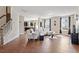 Bright and airy living room with an open layout, hardwood floors, and large windows with window treatments at 220 Outwater Ridge Dr, Garner, NC 27529