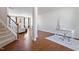 Open-concept living room featuring hardwood floors, a white color scheme, and a defined office space at 220 Outwater Ridge Dr, Garner, NC 27529