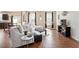 Inviting living room featuring wood floors, a white couch, and natural light, with an adjacent dining area at 220 Outwater Ridge Dr, Garner, NC 27529