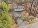 Stunning aerial view of a charming home with a private driveway surrounded by lush greenery and mature trees at 2224 Clements Dr, Durham, NC 27704