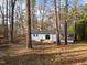 Aerial view of back of house features a wooden deck with steps, and screened in porch at 2224 Clements Dr, Durham, NC 27704