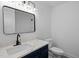 Modern bathroom featuring navy blue vanity, quartz countertop, and stylish fixtures at 2224 Clements Dr, Durham, NC 27704