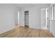 Light-filled bedroom showcasing hardwood floors and connecting hallway with bathroom at 2224 Clements Dr, Durham, NC 27704