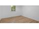Empty bedroom with hardwood floors and a large window, providing plenty of natural light at 2224 Clements Dr, Durham, NC 27704