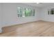 Sun-filled bedroom featuring natural wood floors and large window with serene views at 2224 Clements Dr, Durham, NC 27704