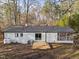 Rear of house features a wooden deck with steps, and screened in porch at 2224 Clements Dr, Durham, NC 27704