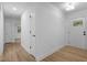 Bright hallway with white walls and hardwood floors, leading to various rooms at 2224 Clements Dr, Durham, NC 27704