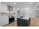 A modern kitchen with stainless steel appliances, shaker cabinets, and a large island at 2224 Clements Dr, Durham, NC 27704