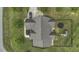 Aerial view of a home with a fenced backyard, playset, and trampoline, surrounded by mature trees at 25 Westbourne Ln, Youngsville, NC 27596