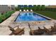 This backyard features a gorgeous pool, chairs, and a fire pit making this the perfect outdoor space at 25 Westbourne Ln, Youngsville, NC 27596