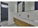 Stylish bathroom featuring a floating double sink vanity, gold fixtures, and an elegant glass-enclosed shower at 25 Westbourne Ln, Youngsville, NC 27596