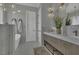 Elegant bathroom with a soaking tub, double vanity, marble counters, and modern lighting fixtures at 25 Westbourne Ln, Youngsville, NC 27596