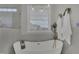 Bright bathroom featuring a modern soaking tub, glass shower, and stylish fixtures and towels at 25 Westbourne Ln, Youngsville, NC 27596