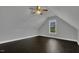 Neutral bedroom featuring hardwood floors, white trim, and a large window to the yard at 25 Westbourne Ln, Youngsville, NC 27596
