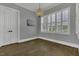 Bright bedroom with hardwood floors, a chandelier, and large windows, offering ample natural light and style at 25 Westbourne Ln, Youngsville, NC 27596