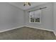 A neutral bedroom with carpet, fan and a large window to provide lots of light at 25 Westbourne Ln, Youngsville, NC 27596