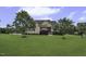 Charming two-story home featuring a well-manicured lawn, mature trees, and welcoming front porch at 25 Westbourne Ln, Youngsville, NC 27596