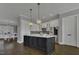 Spacious eat-in kitchen showcases a large island, stainless appliances, and stylish lighting at 25 Westbourne Ln, Youngsville, NC 27596
