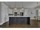 Spacious eat-in kitchen showcases a large island, stainless appliances, and stylish lighting at 25 Westbourne Ln, Youngsville, NC 27596