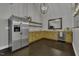 Modern kitchen with stainless steel refrigerator and wooden cabinets, featuring dark hardwood floors at 25 Westbourne Ln, Youngsville, NC 27596