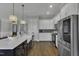 Bright kitchen features a large island, stainless steel appliances, and custom cabinets at 25 Westbourne Ln, Youngsville, NC 27596