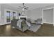 Spacious living room with hardwood floors, a fireplace, and French doors, offering natural light and style at 25 Westbourne Ln, Youngsville, NC 27596