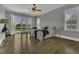 Airy main bedroom with hardwood floors, French doors to a balcony, and generous light from large windows at 25 Westbourne Ln, Youngsville, NC 27596