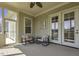 Covered patio with two armchairs overlooking the lush garden, ideal for relaxation at 25 Westbourne Ln, Youngsville, NC 27596