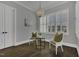 Cozy sitting room with a chandelier and plantation shutters allowing lots of natural light at 25 Westbourne Ln, Youngsville, NC 27596