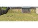 Expansive backyard featuring a wooden storage shed and a full wooden privacy fence at 259 Brassfield Dr, Burlington, NC 27217