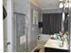 Bathroom featuring a marble shower and vanity with storage at 259 Brassfield Dr, Burlington, NC 27217