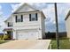 View of two-story home featuring a two-car garage, neutral siding, and black shutters at 259 Brassfield Dr, Burlington, NC 27217