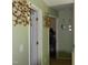 Hallway with doorway leading to a bonus space with workout equipment at 259 Brassfield Dr, Burlington, NC 27217