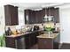 Well-equipped kitchen featuring dark wood cabinets, stainless steel appliances, and granite countertops at 259 Brassfield Dr, Burlington, NC 27217