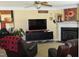 Living room featuring comfortable seating, entertainment center, and neutral carpeting at 259 Brassfield Dr, Burlington, NC 27217